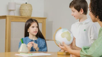 A woman teaches children about - Credits: pexels