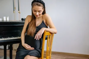 Pregnant woman in black dress - Credits: pexels