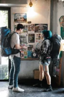 A young couple with backpacks - Credits: pexels