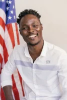 Smiling man with 'I Voted' - Credits: pexels