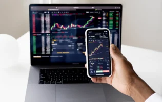 Person checking stock market graphs - Credits: pexels