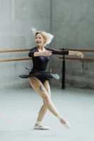 A cheerful female ballerina performing - Credits: pexels