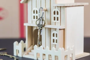 Miniature wooden house with a - Credits: pexels