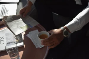 Businessman holding a coffee cup - Credits: pexels