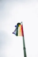 Vibrant LGBTQ pride flag waving - Credits: pexels
