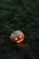 A spooky carved pumpkin glowing - Credits: pexels