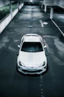 A luxury white car parked - Credits: pexels