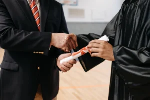 Close-up of a graduate receiving - Credits: pexels