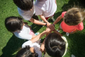 Top-view of children joining hands - Credits: pexels