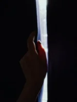 Shadowed hand opening dark curtains, - Credits: pexels