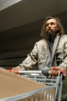 Bearded man in worn clothing - Credits: pexels