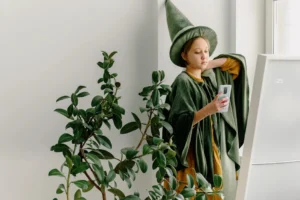 Teen in wizard costume using - Credits: pexels