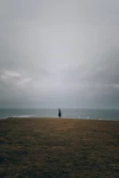 A lone figure stands on - Credits: pexels