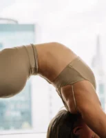 A woman practices yoga indoors - Credits: pexels