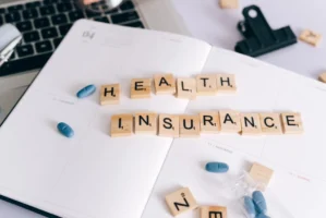 Scrabble tiles spelling 'Health Insurance' - Credits: pexels